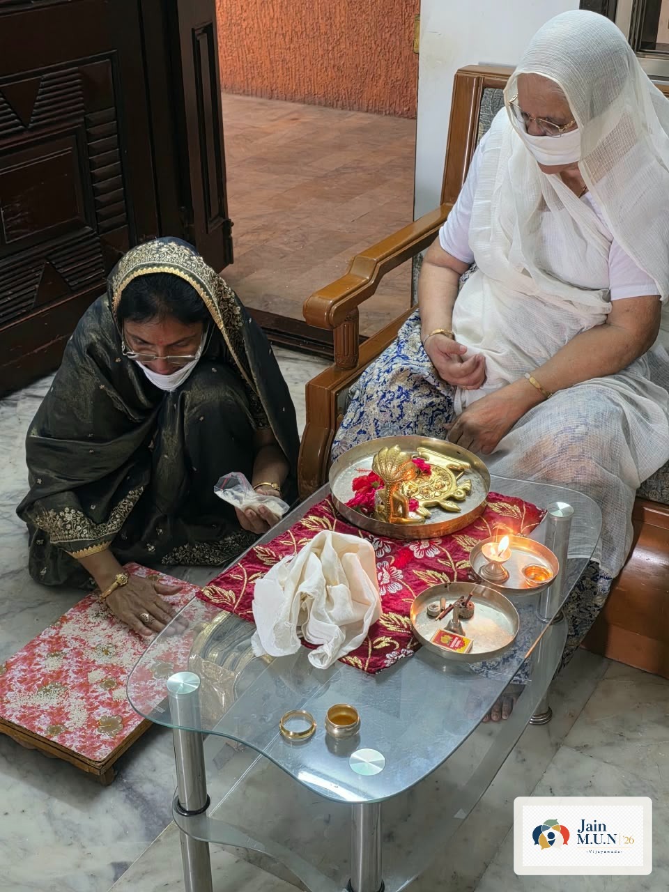 Puja seva shared with an elderly devotee at home.