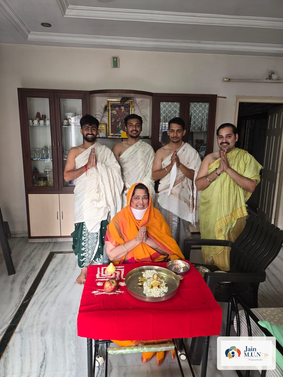 Seva volunteers with a devotee after home puja.