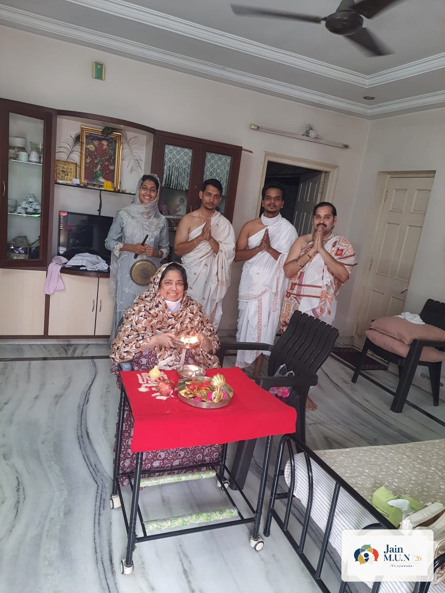 Aarti and darshan at the close of a home-puja visit.